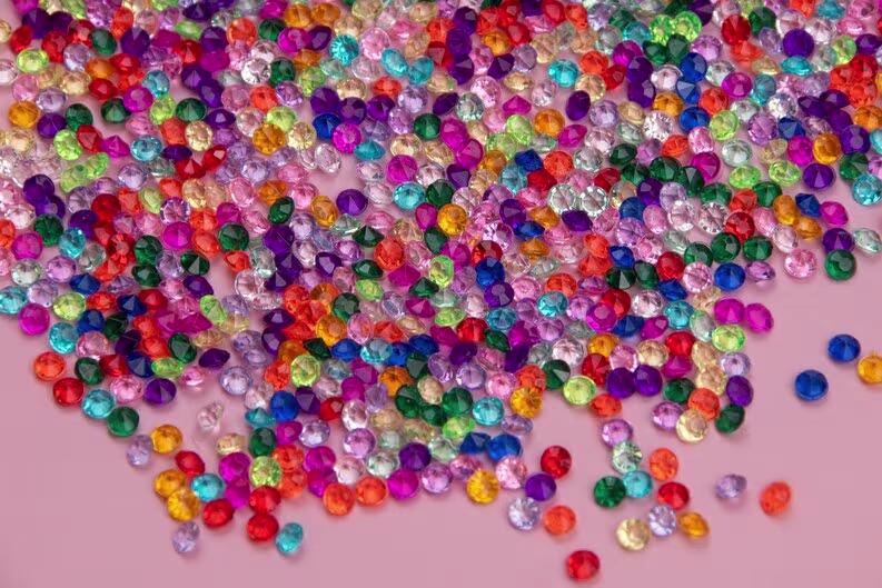 colorful diamonds pink background top view